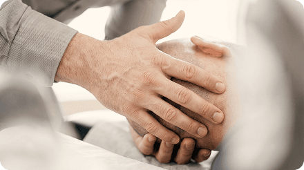 Hands treating a patient's neck for a herniated disc